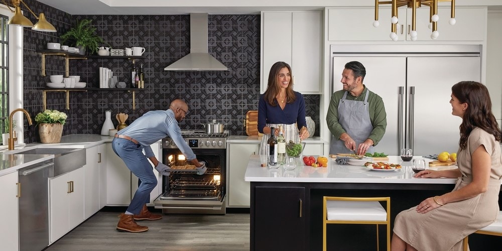 Group of four friends chatting in a Frigidaire Professional Appliances Kitchen
