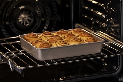 Cinnamon Rolls in a baking dish in an oven